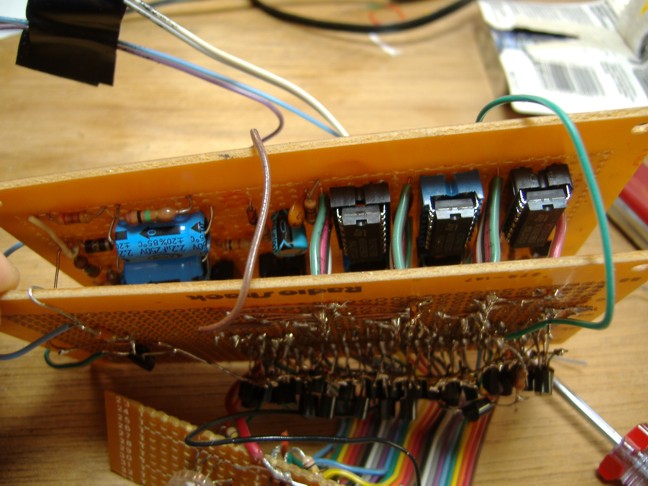 Closeup of the area between two perfboards, showing the control ICs.